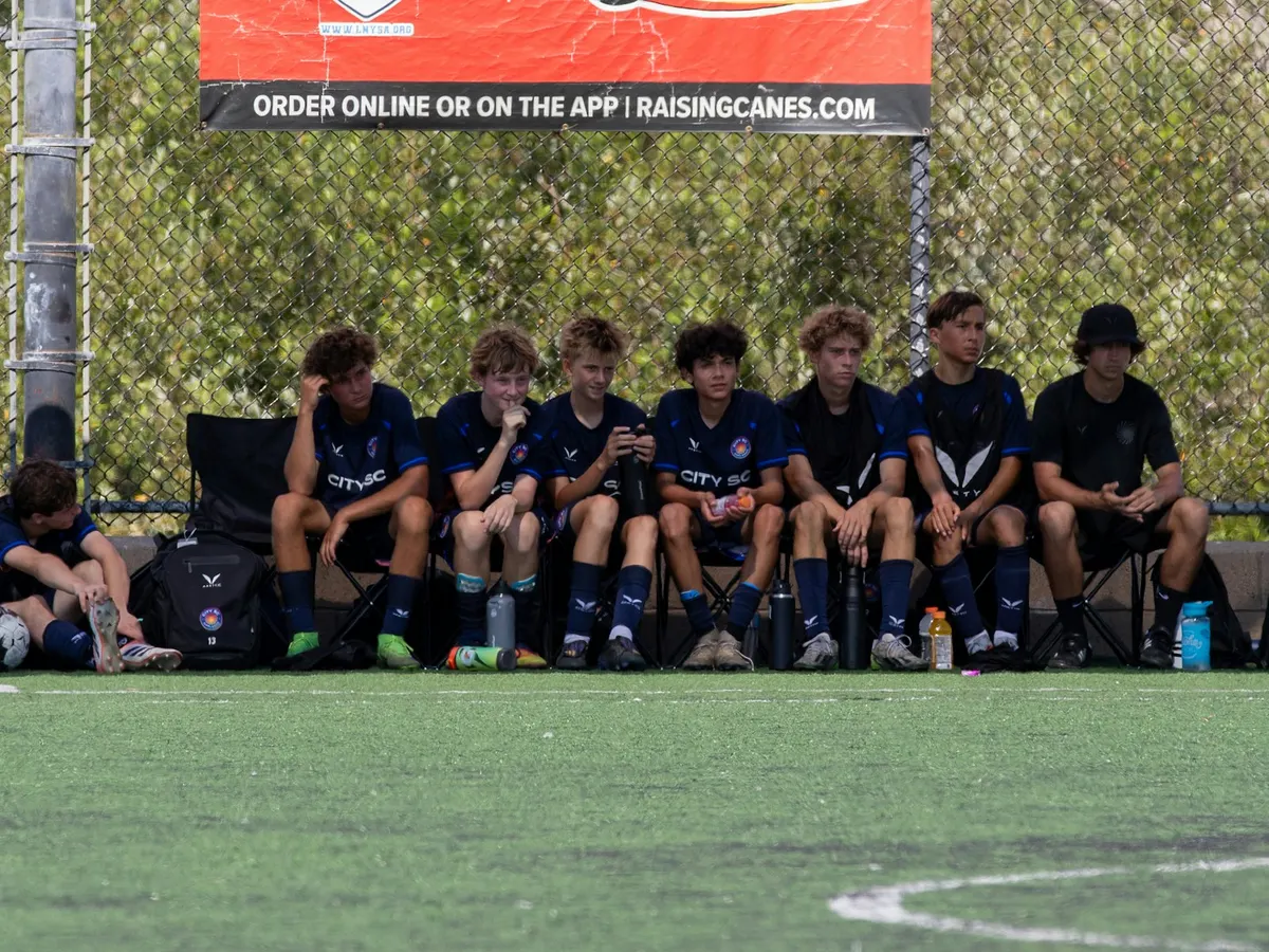Jeunes footballeurs assis sur le banc pendant un match